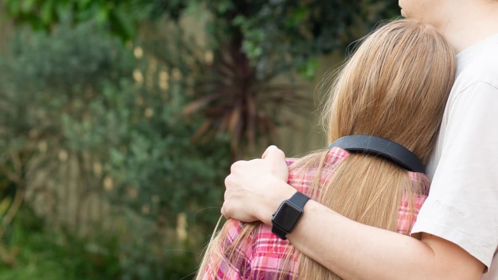 father-hugs-teenage-daughter